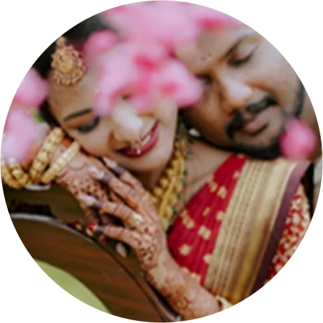 Couple sharing a moment beneath pink flowers